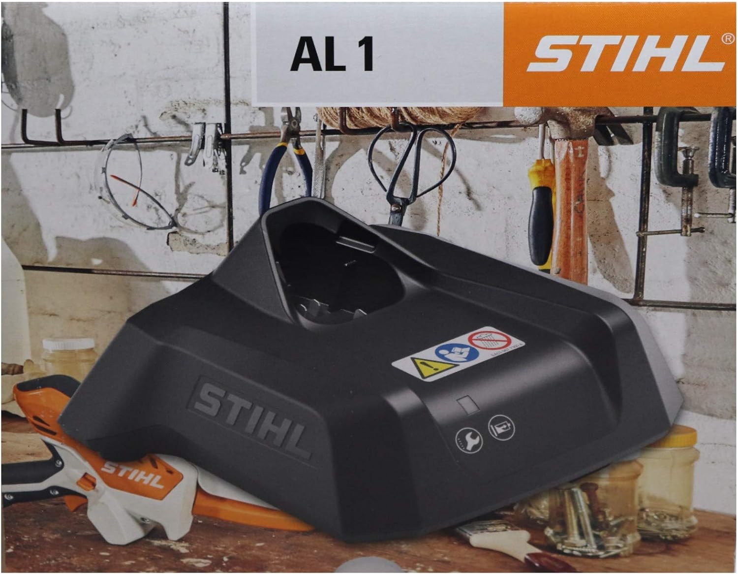 Caricabatterie STIHL AL 1 per attrezzi da giardino, in un'officina con strumenti appesi. Design robusto e compatto, ideale per ricaricare batterie di dispositivi STIHL. Perfetto per giardinieri e hobbisti. Acquista ora su STIHL.