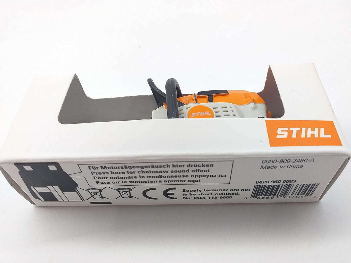 Giocattolo motosega Stihl in confezione, modello 0000-900-2460-A, Made in China. Premere per effetto sonoro motosega. Codice a barre 886661937042. Non cortocircuitare terminali di alimentazione. Manuale incluso.